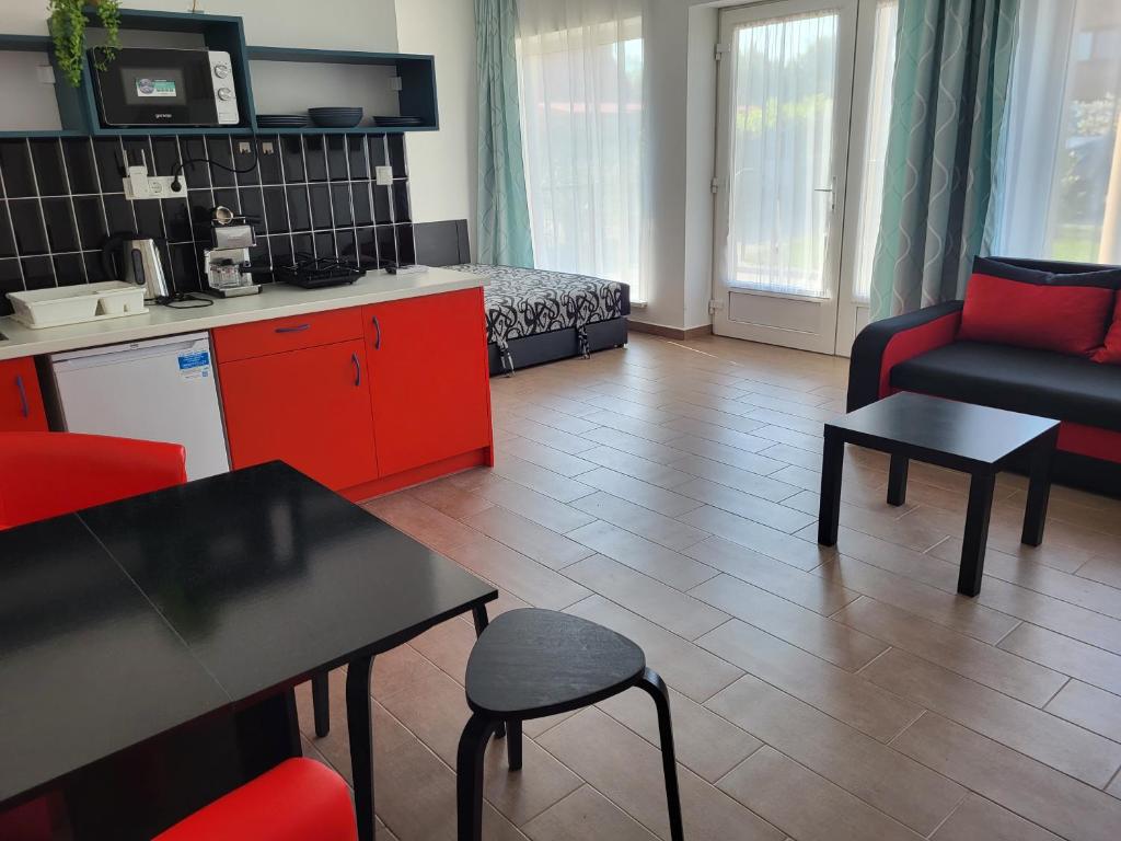 a room with a kitchen and a living room at Villa Balifornia in Balatonboglár