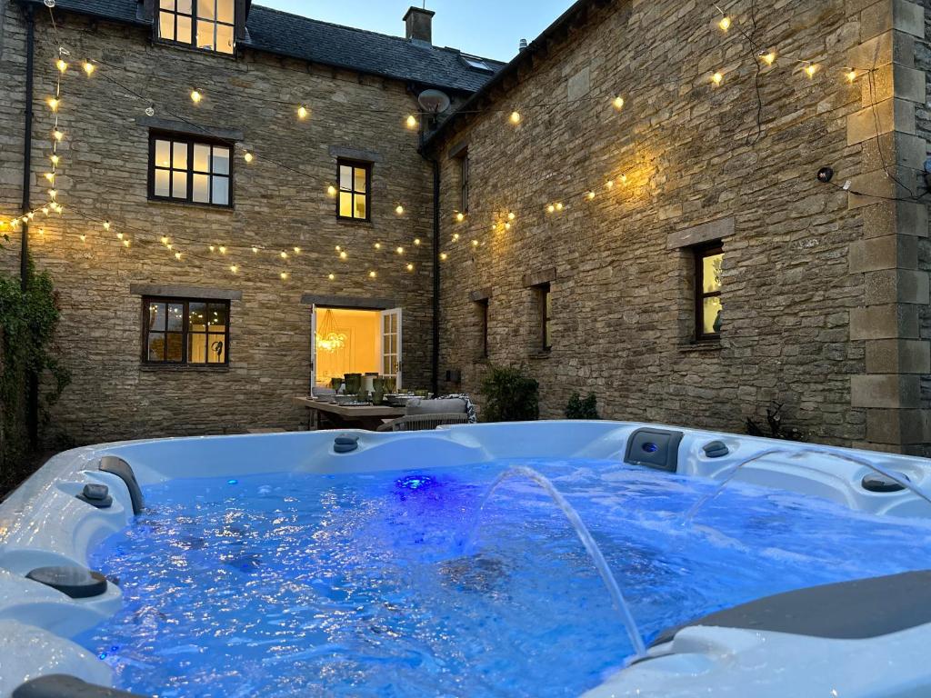 a hot tub in the backyard of a building at Cotswolds Retreat - Bath & Castle Combe - Hot Tub in Chippenham