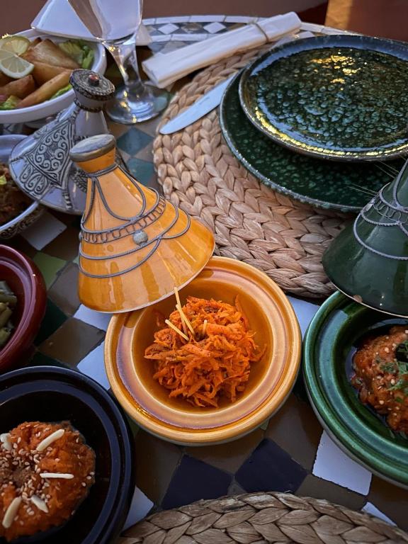 a table topped with plates of food on a table at Riad El Youssoufi in Marrakesh