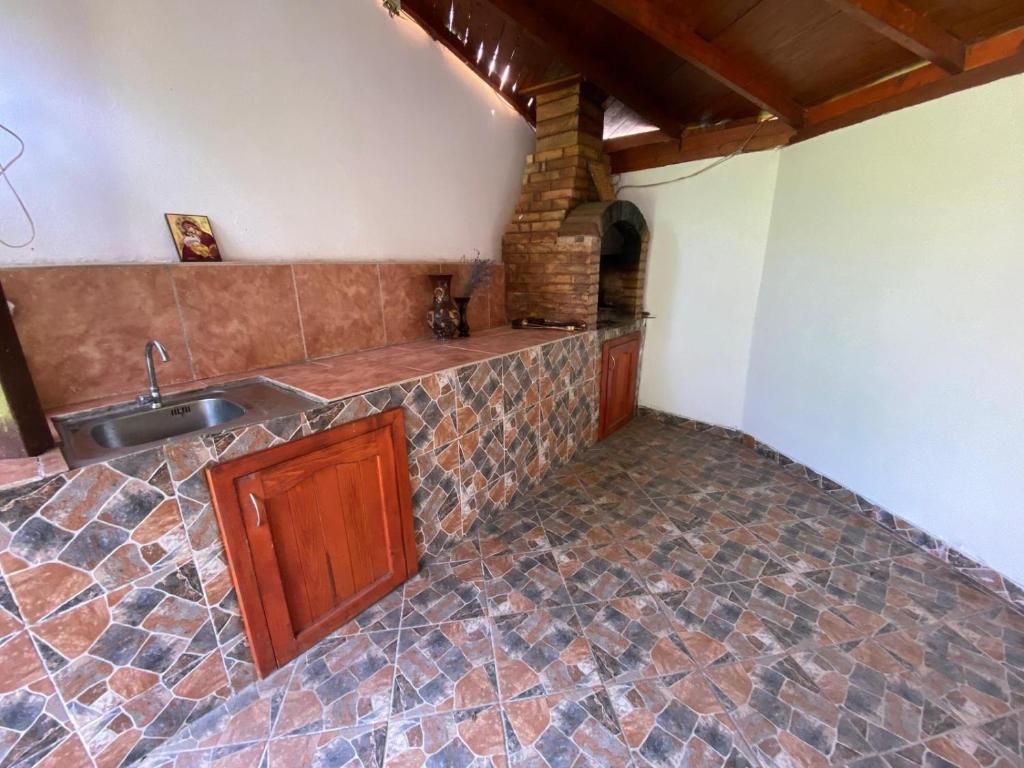 a kitchen with a sink and a counter at Casa Izvorul Rece in Hobiţa