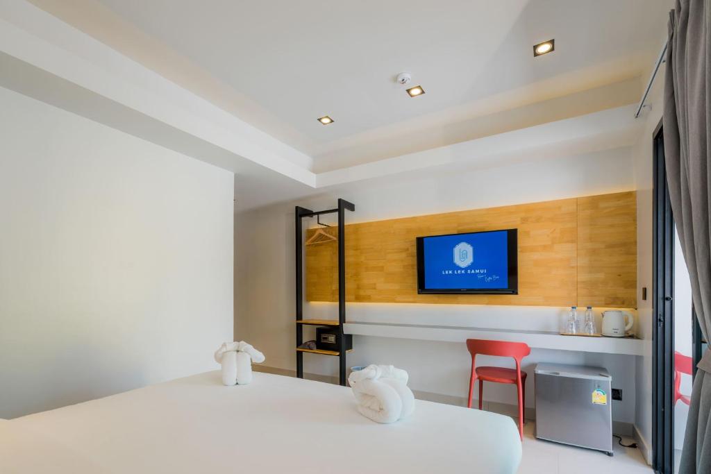 Postel nebo postele na pokoji v ubytování Lek Lek Samui Room X Coffee Bar