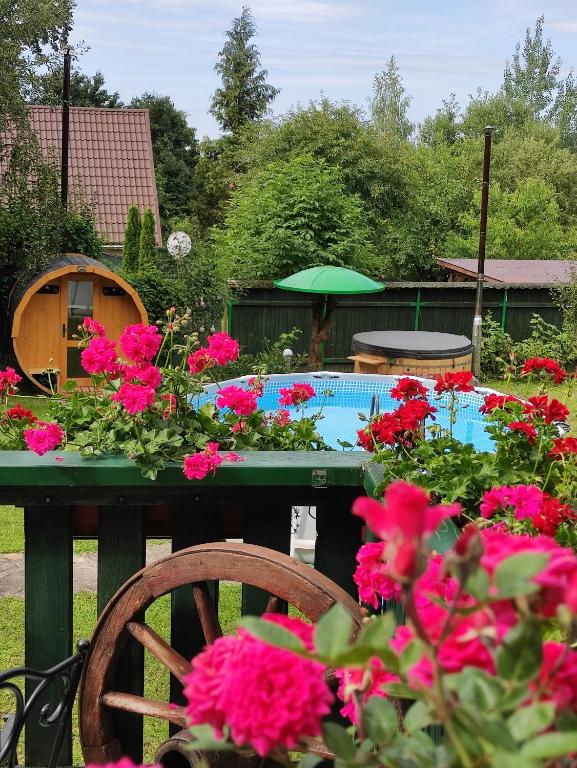 a table with flowers in front of a pool at Casă de vacanță Chalet le Cristal in Sovata