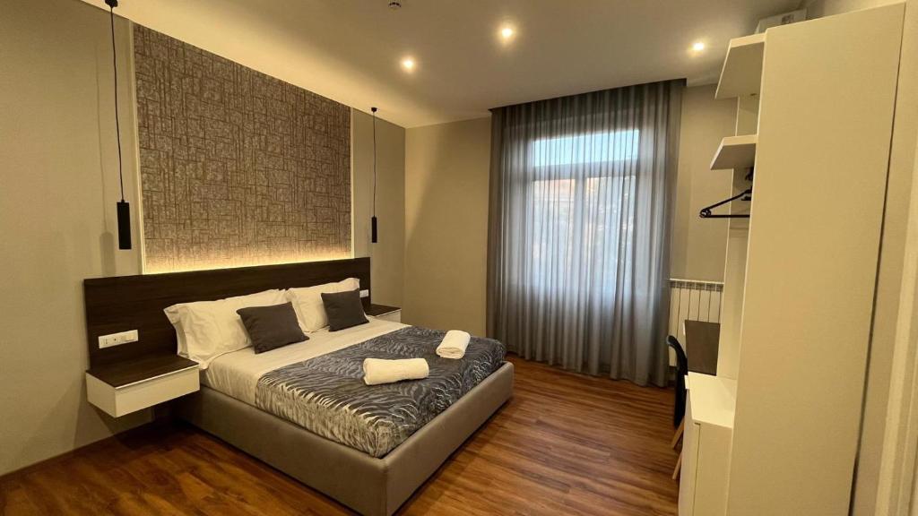 a bedroom with a bed and a large window at B&B MariLù in Foggia