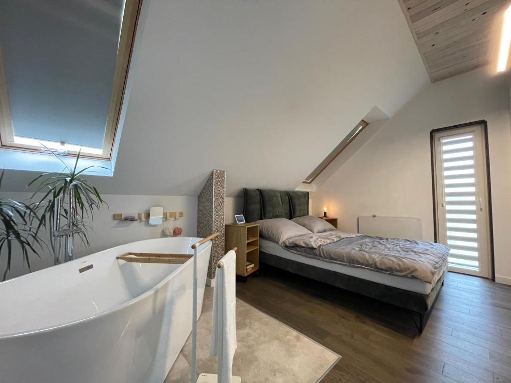a bedroom with a bed and a bath tub at Appena Guest House 2 in Krakow