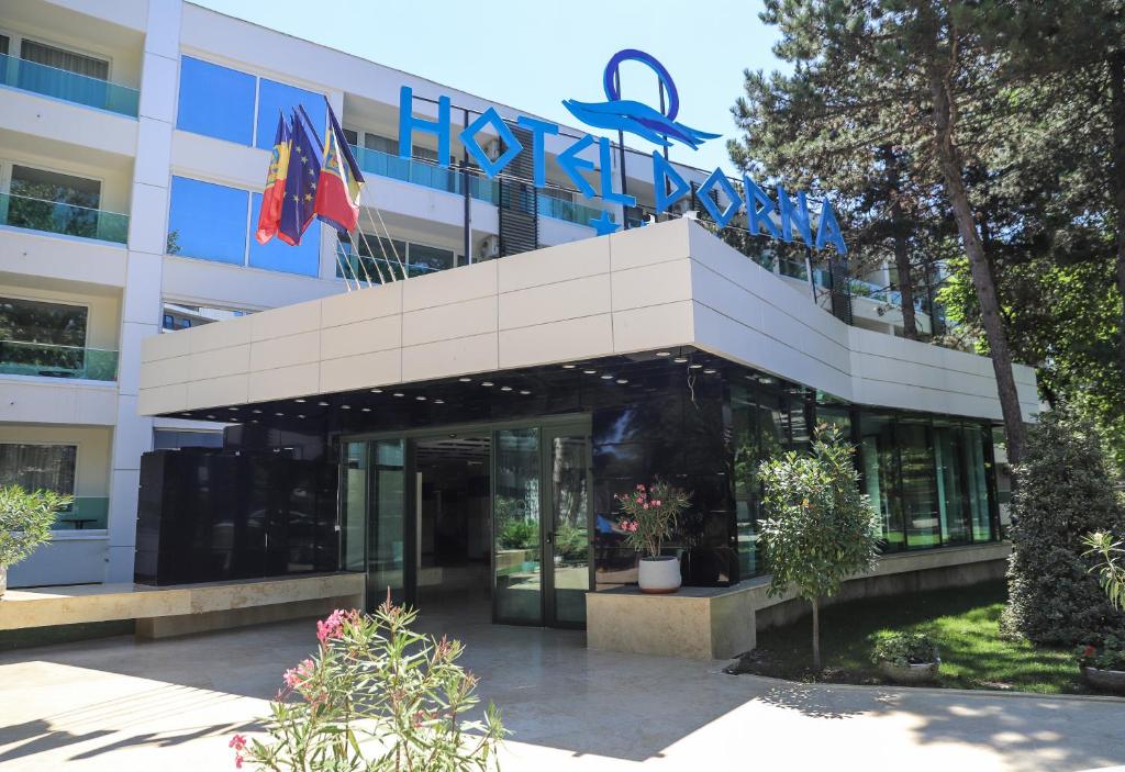 a building with a sign on top of it at Hotel Dorna in Mamaia