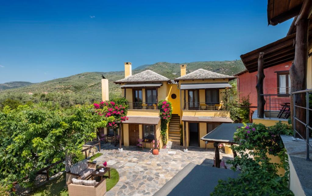 a view of a house with mountains in the background at Alkifron Hotel in Kala Nera