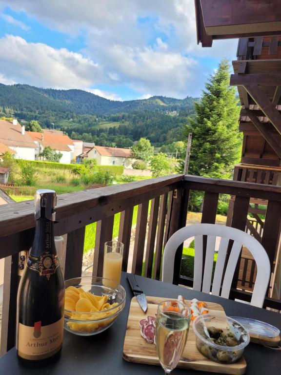 a bottle of wine sitting on a table with food at Appartement chaleureux au cœur des Hautes Vosges in Ventron