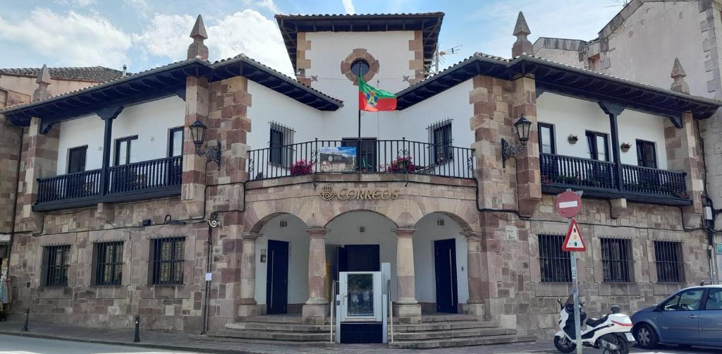 a building with a flag on top of it at Apartamento Corazón de Liébana in Potes