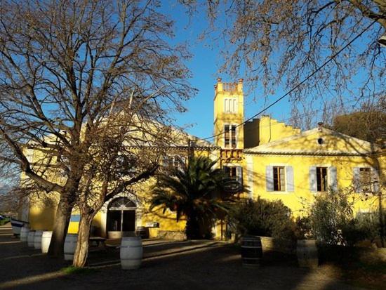 a large yellow building with a tower on top of it at Bateau Mariance in Ginestas