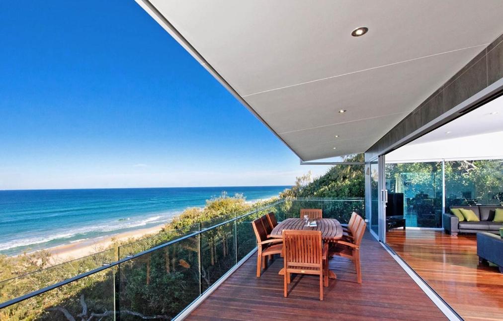 a dining room with a view of the ocean at 28 Park Crescent, Sunshine Beach in Noosa Heads