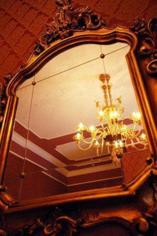a mirror with a chandelier in front at Residenza Hotel San Maurizio in Venice