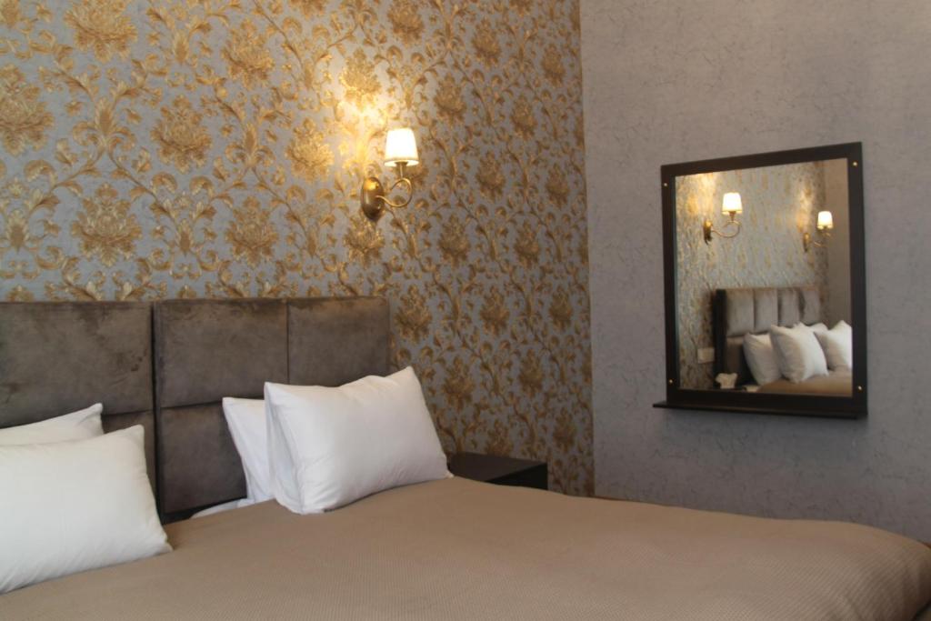 Postel nebo postele na pokoji v ubytování Hotel 1883