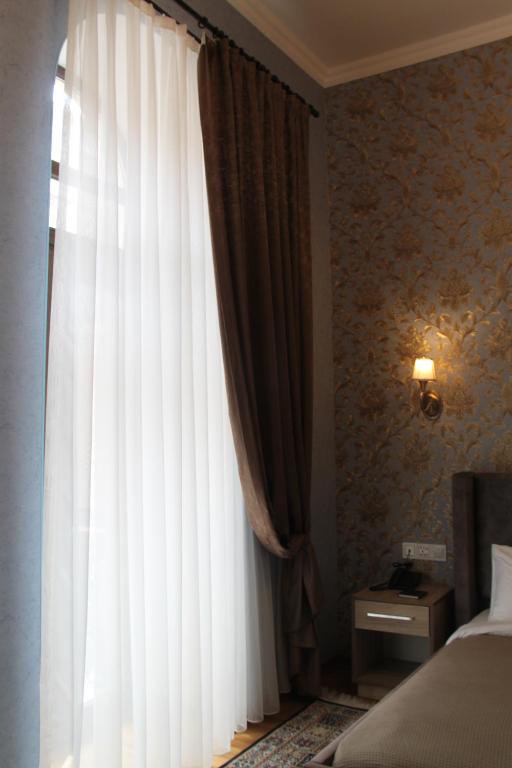 Postel nebo postele na pokoji v ubytování Hotel 1883