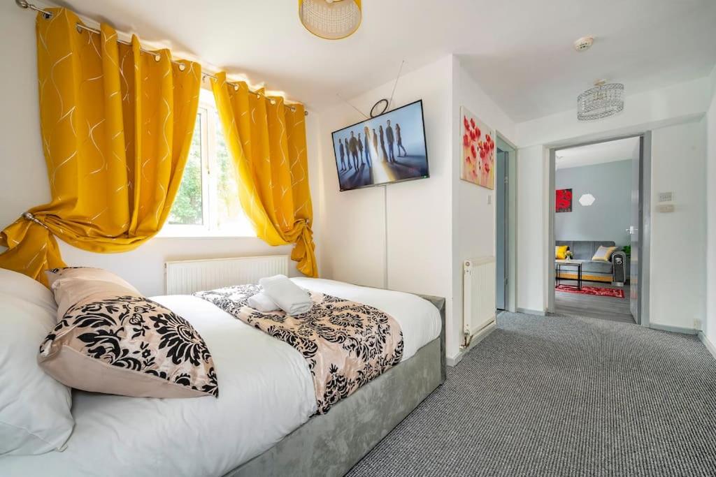 a bedroom with two beds and yellow curtains at *F6GH For your most relaxed & cosy stay + FREE PARKING & WiFi in Bramley
