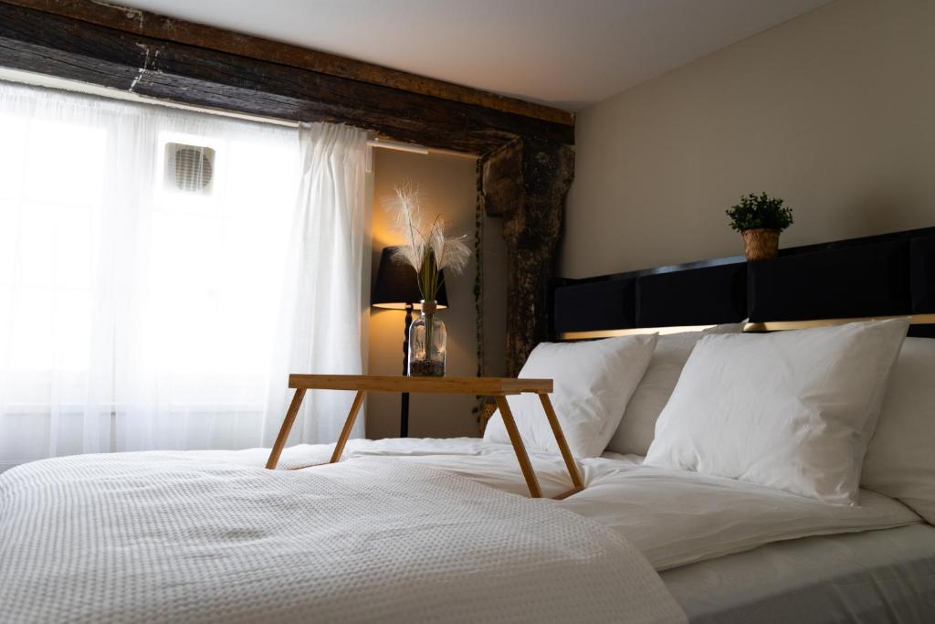 a bedroom with a bed with a table on it at Goethe House in old town Zürich in Zurich