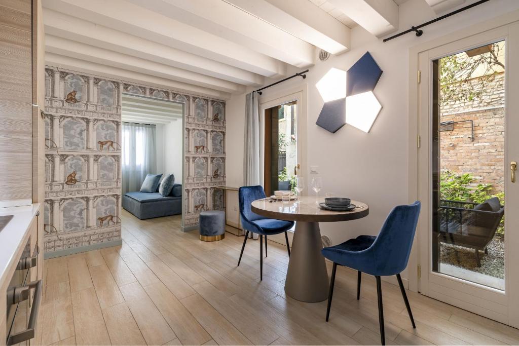 ヴェネツィアにあるCa' San Carlo Residenceのダイニングルーム(テーブル、青い椅子付)