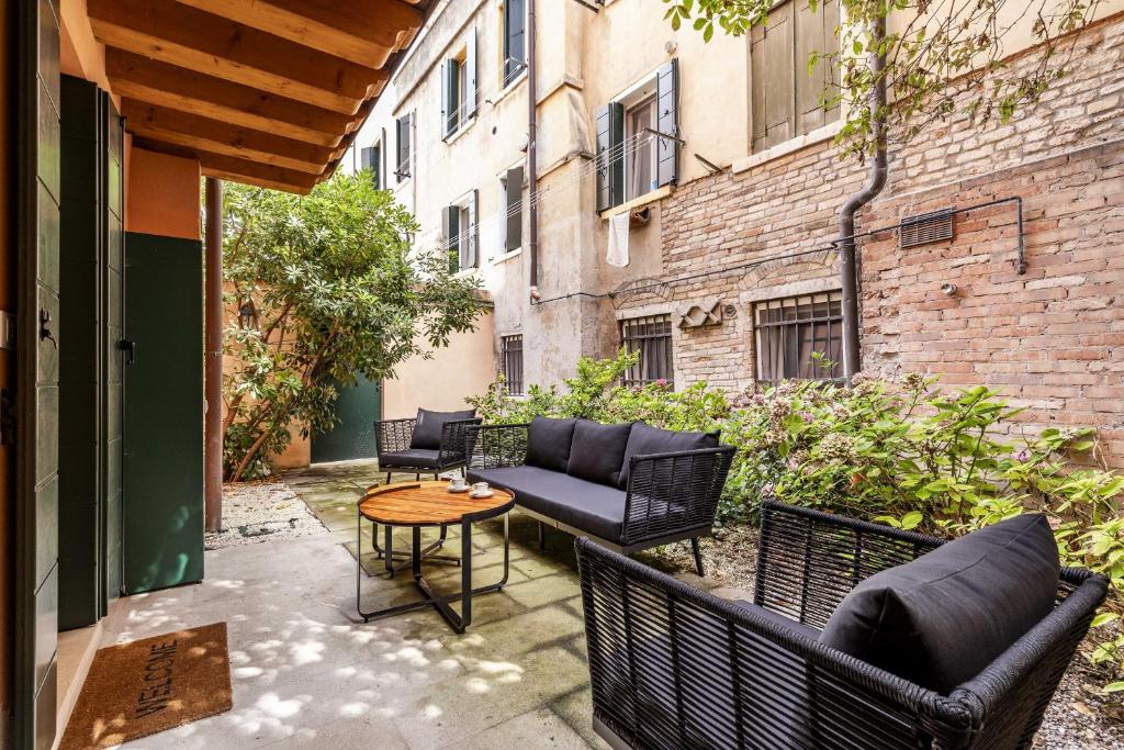 a patio with couches and a table on a balcony at Ca' San Carlo Residence by Wonderful Italy in Venice