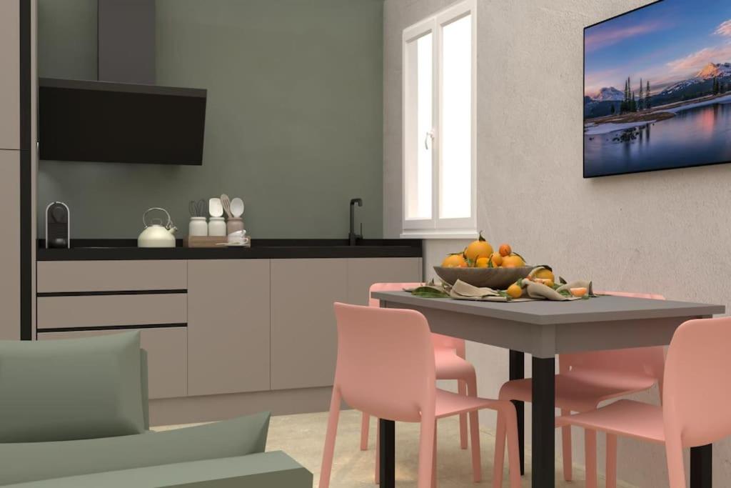 a kitchen with a table with a bowl of fruit on it at David Design Apartment centro storico in Caorle