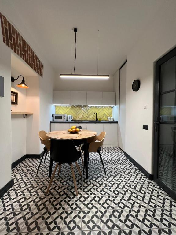 a kitchen and dining room with a table and chairs at Art Apartment Glebova in Lviv