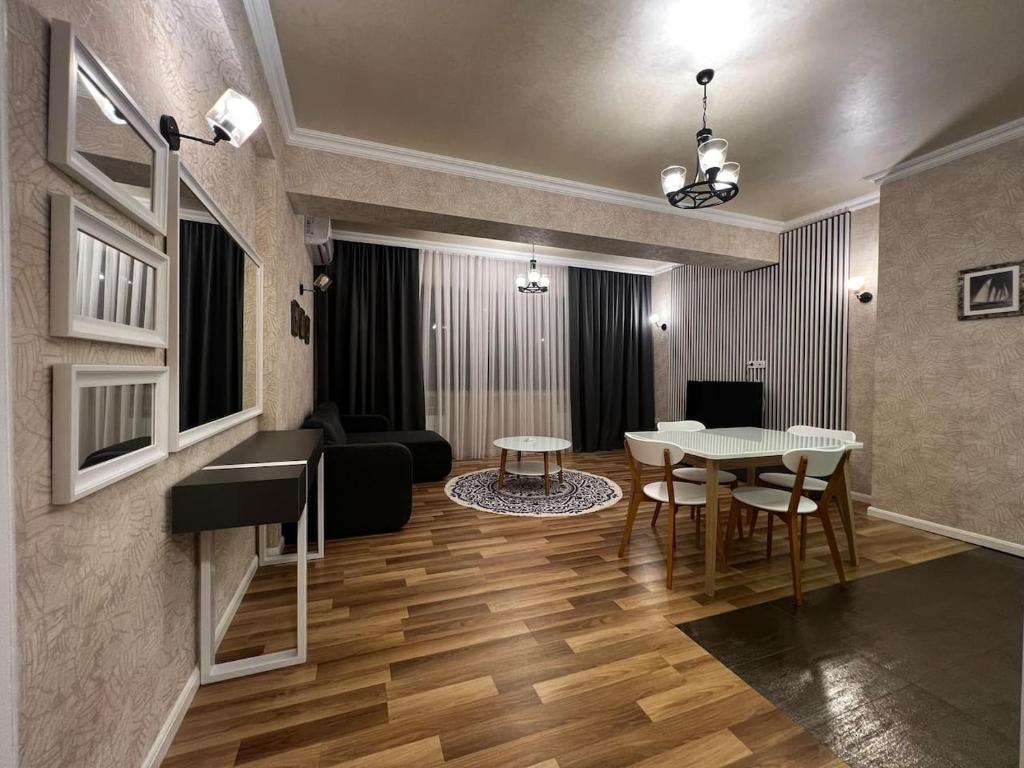 a living room with a table and a couch at Park Azure 0568 in Baku