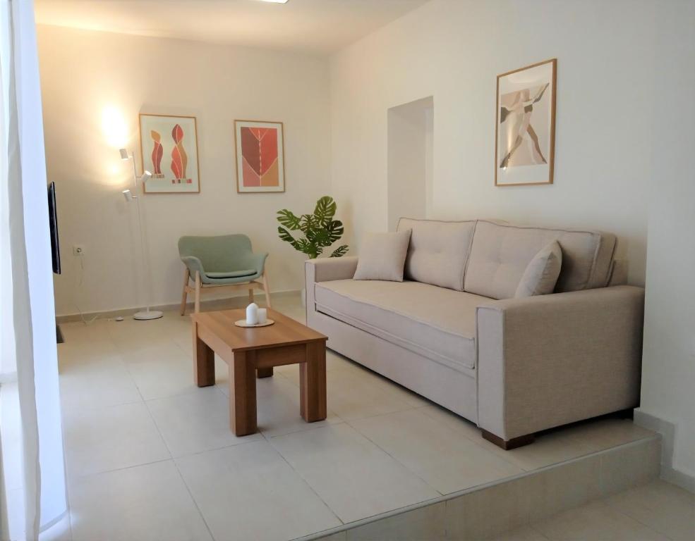 a living room with a couch and a table at Minas House in Alikianós