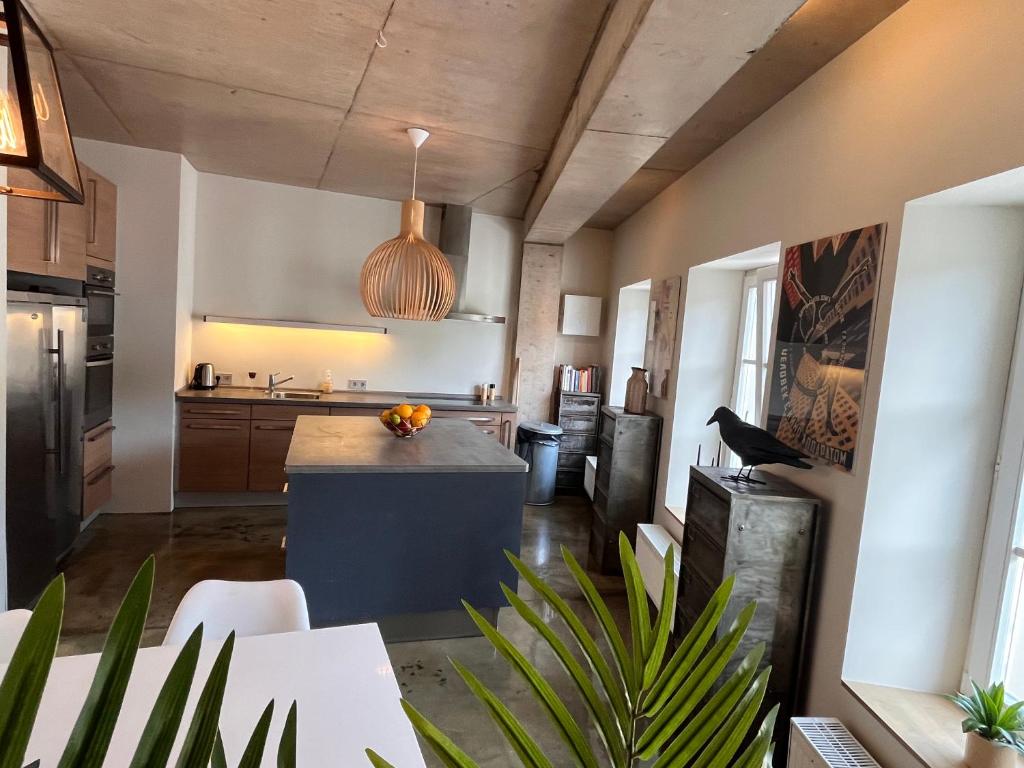 a kitchen with a island in the middle of a room at Ancien Cinema Loft in Vianden