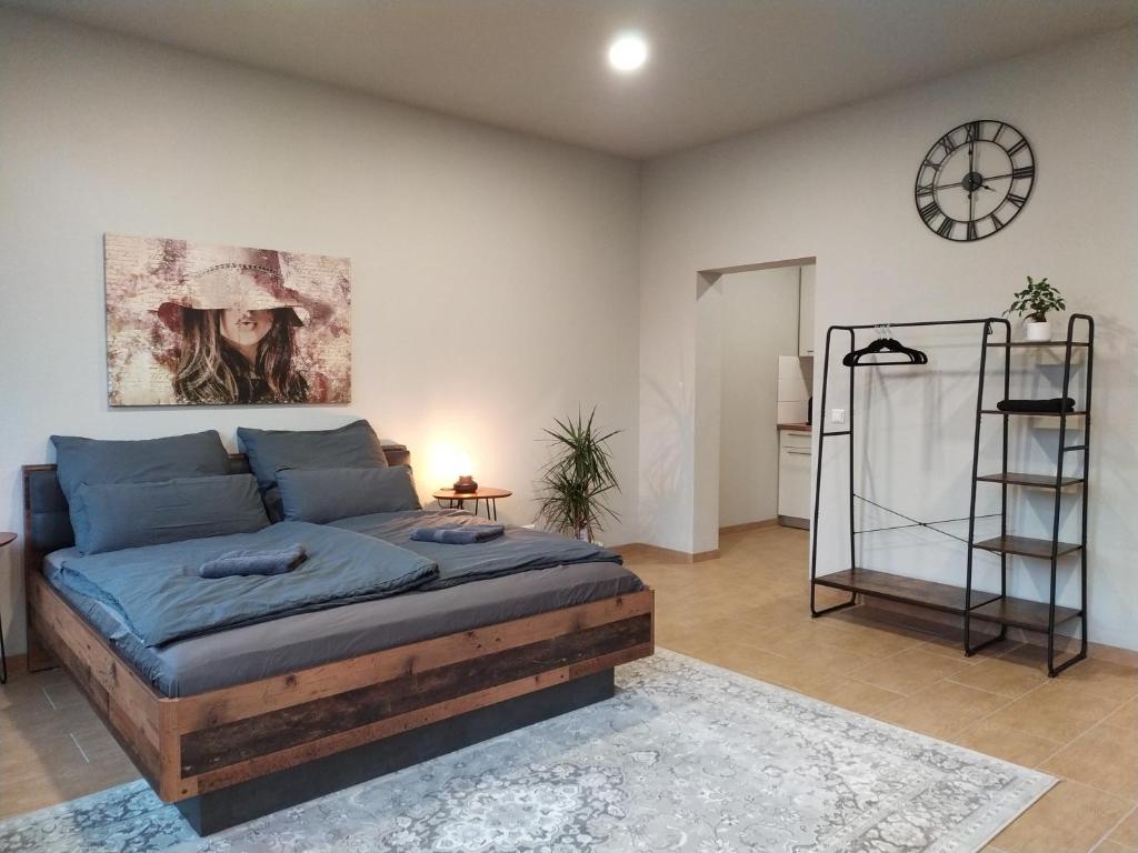 a bedroom with a bed and a clock on the wall at Andris Apartments in Stuttgart