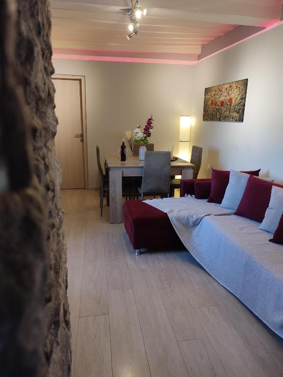 a bedroom with a bed and a dining room with a table at Aegean View in Ermoupoli