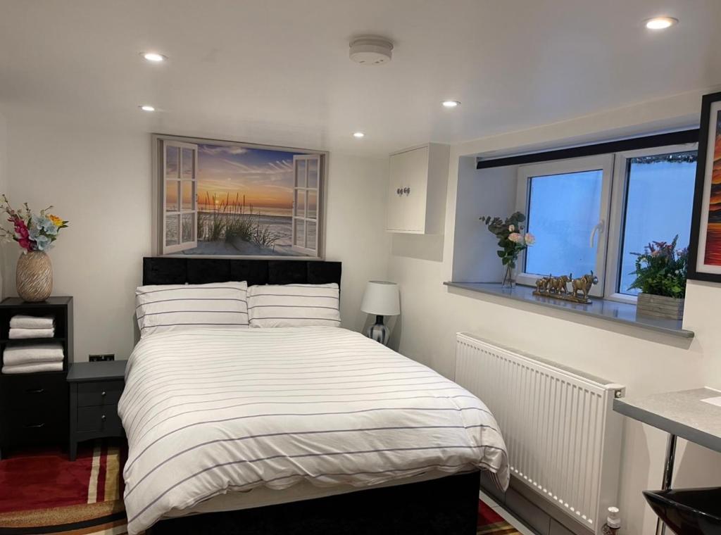 a bedroom with a bed and two windows at Lux Double Bed Studio by town & beach in Ryde