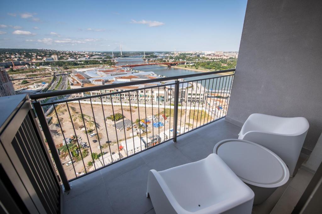 a balcony with two toilets and a view of a harbor at Belgrade Waterfront Residences - Beograd na vodi in Belgrade