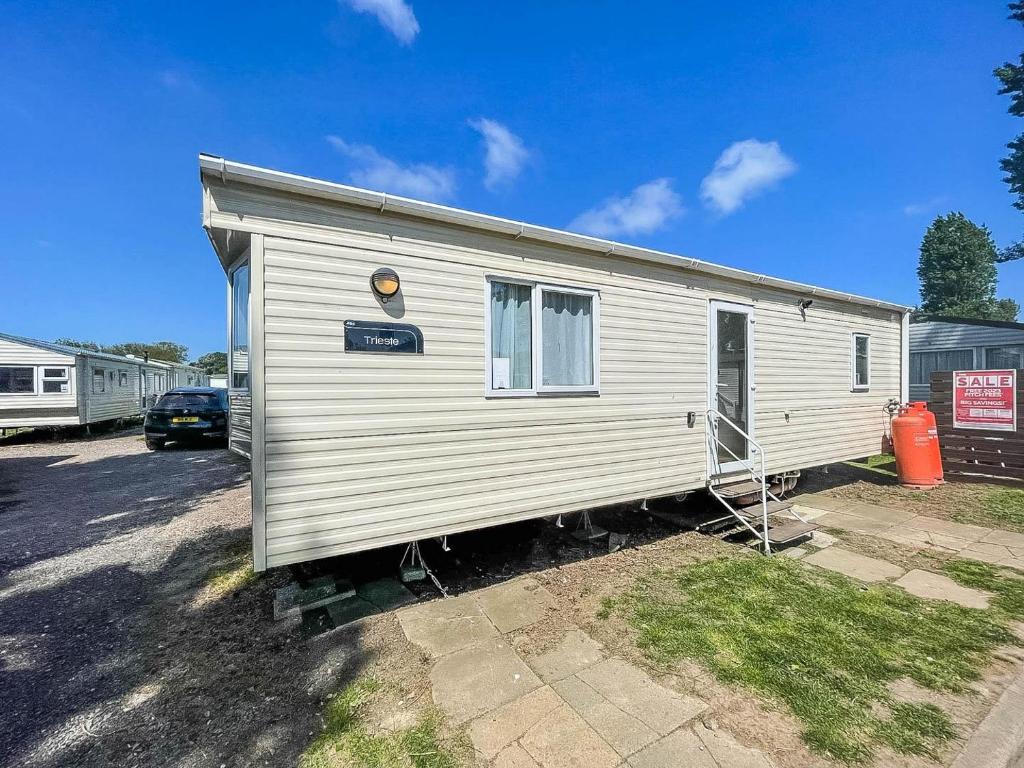 a mobile home is parked in a parking lot at Lovely 4 Berth Holiday Home At Felixstowe Beach Holiday Park Ref 55008yc in Walton
