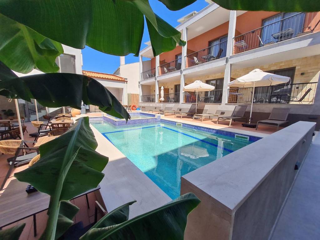 a swimming pool in front of a building at Maltepe Luxury Accommodation by Travel Pro Services in Kallithea Halkidikis