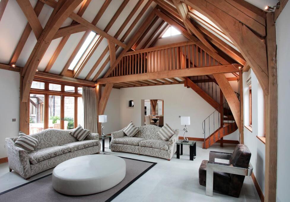 a living room with two couches and a table at Whytings Stud Barn 2 in Horsham