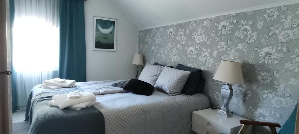 a bedroom with a bed with a blue and white wall at Kortteer sininen huoneisto in Rauma