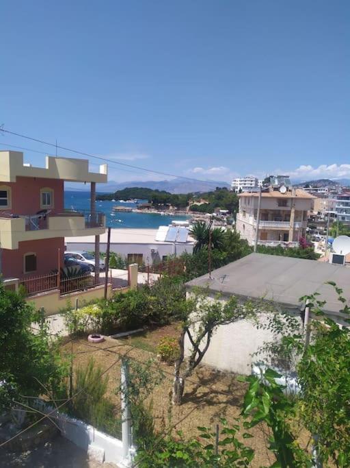a view of a city with a building and a harbor at Λευκό σπίτι in Ksamil