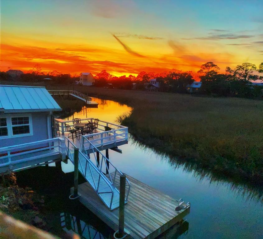 a house on a dock on a river at sunset at Creekside Paradise in Tybee Island
