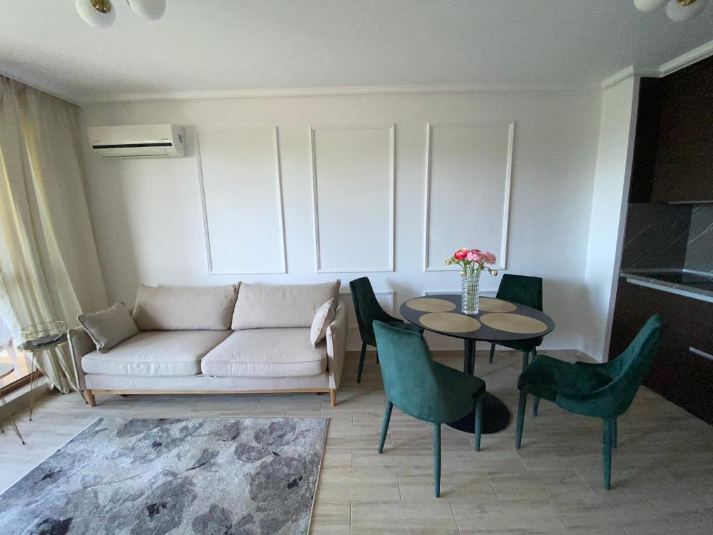 a living room with a couch and a table and chairs at LUXURIOUS COMFORT IN CASCADAS in Sunny Beach