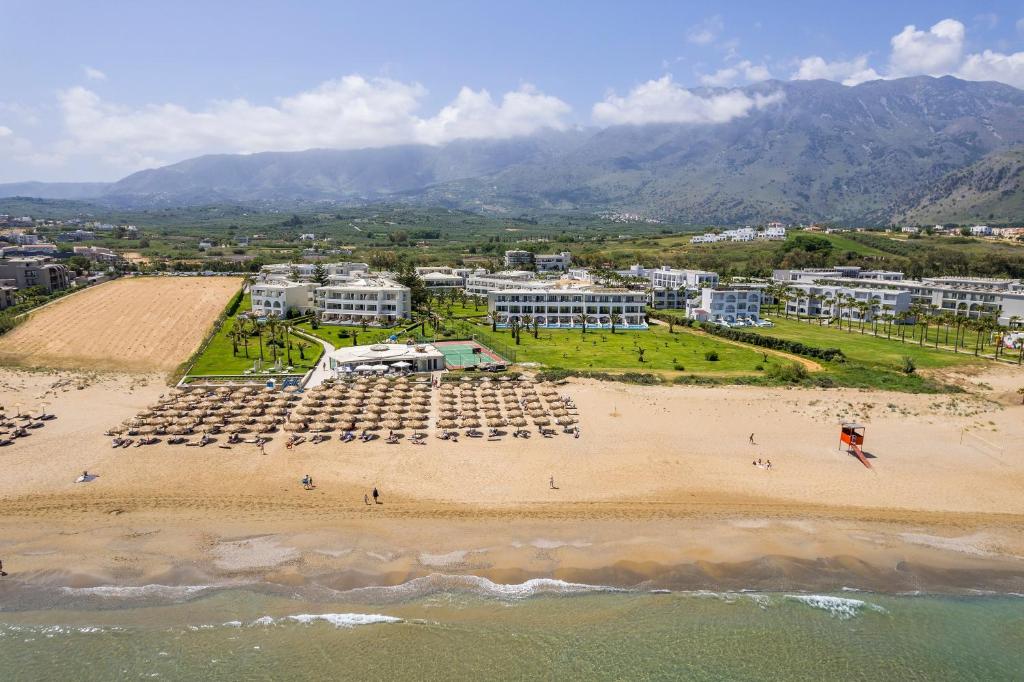 an aerial view of a beach and buildings at Vantaris Palace in Georgioupolis