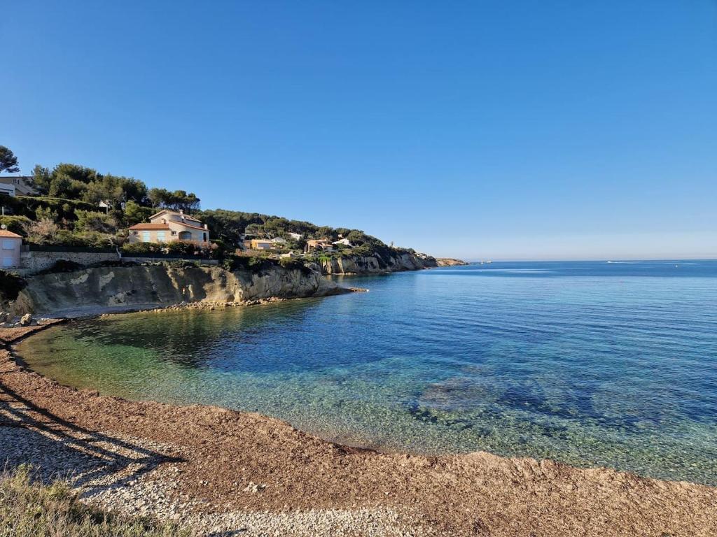 une plage d'eau bleue et une maison sur la côte dans l'établissement Petit Beaucours, à Sanary-sur-Mer