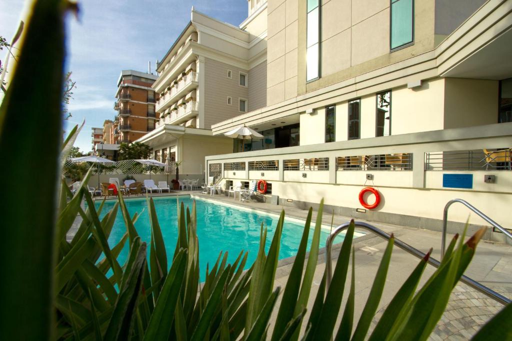 a swimming pool in the middle of a building at Hotel Nord Est in Rimini