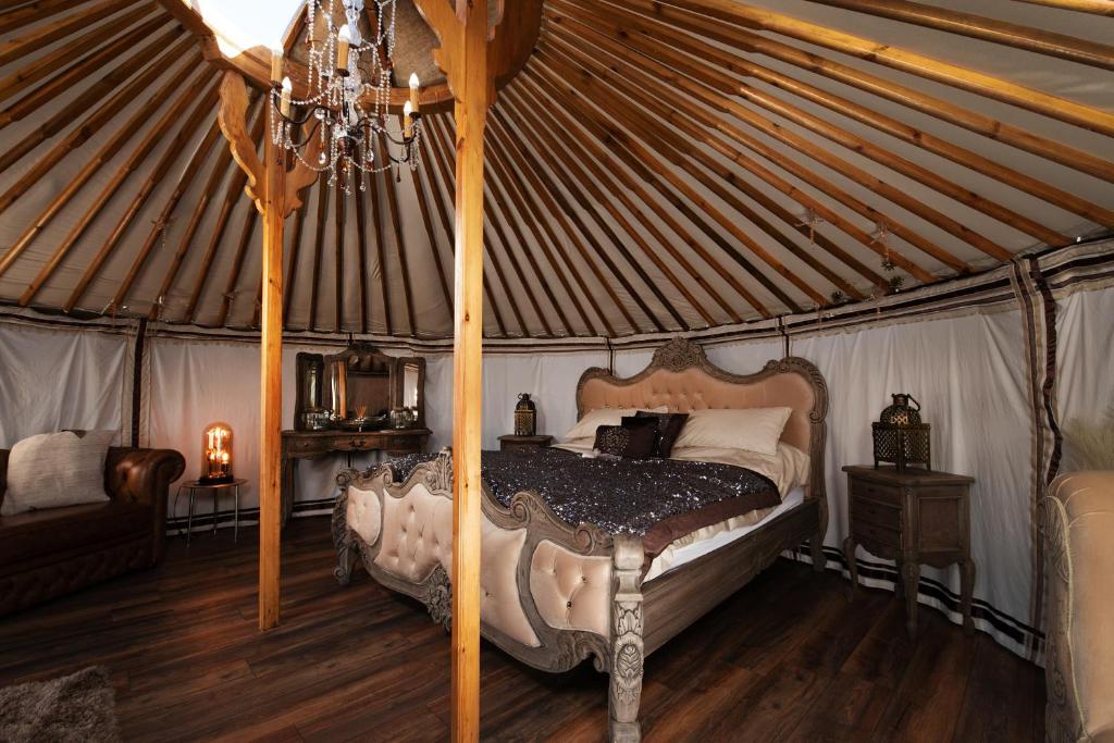 a bedroom with a canopy bed in a yurt at Lincoln Yurts in Lincoln