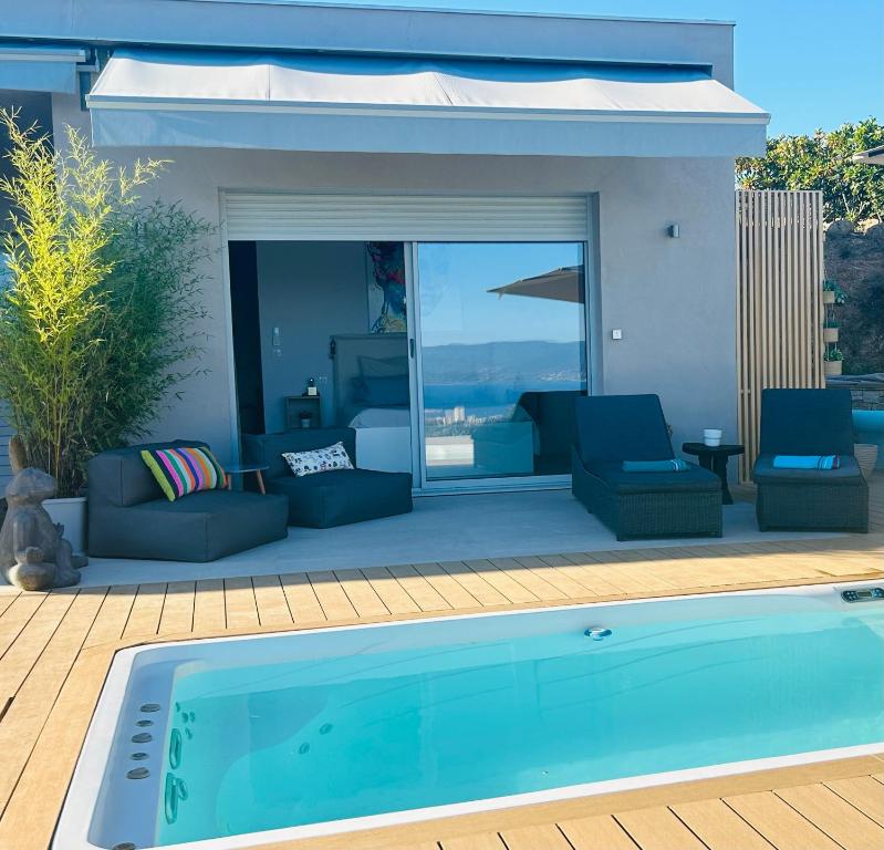 a swimming pool in front of a house at CASA LC chambre3 vue mer SPA de NAGE in Ajaccio