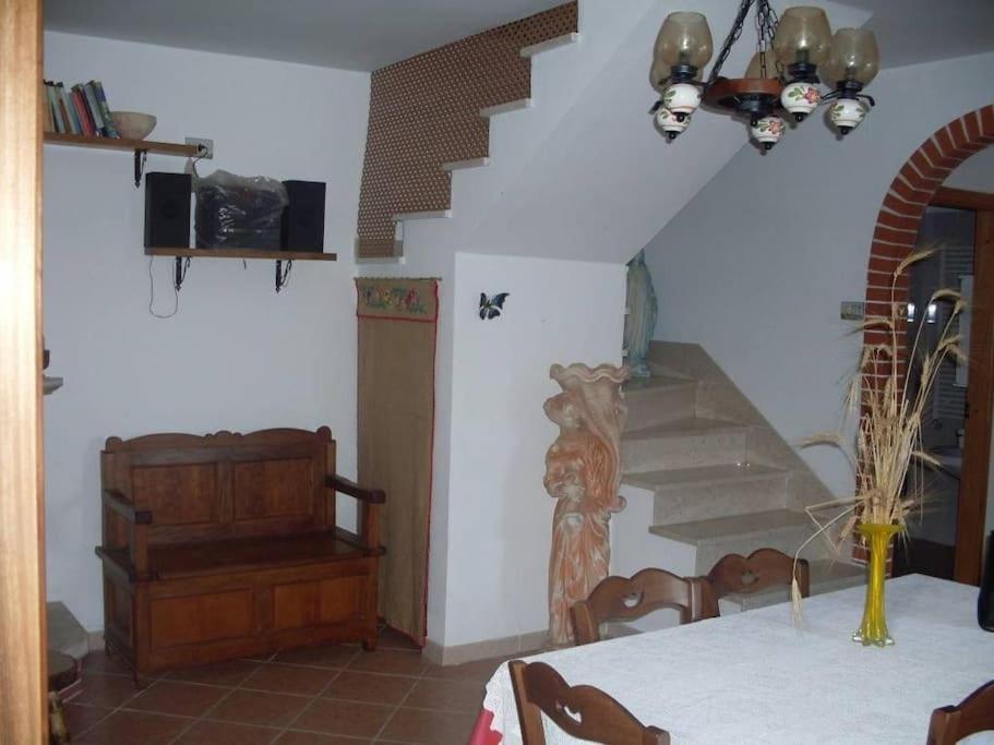 a dining room with a table and a staircase at Casa Vacanze Le Vigne in Rionero Sannitico