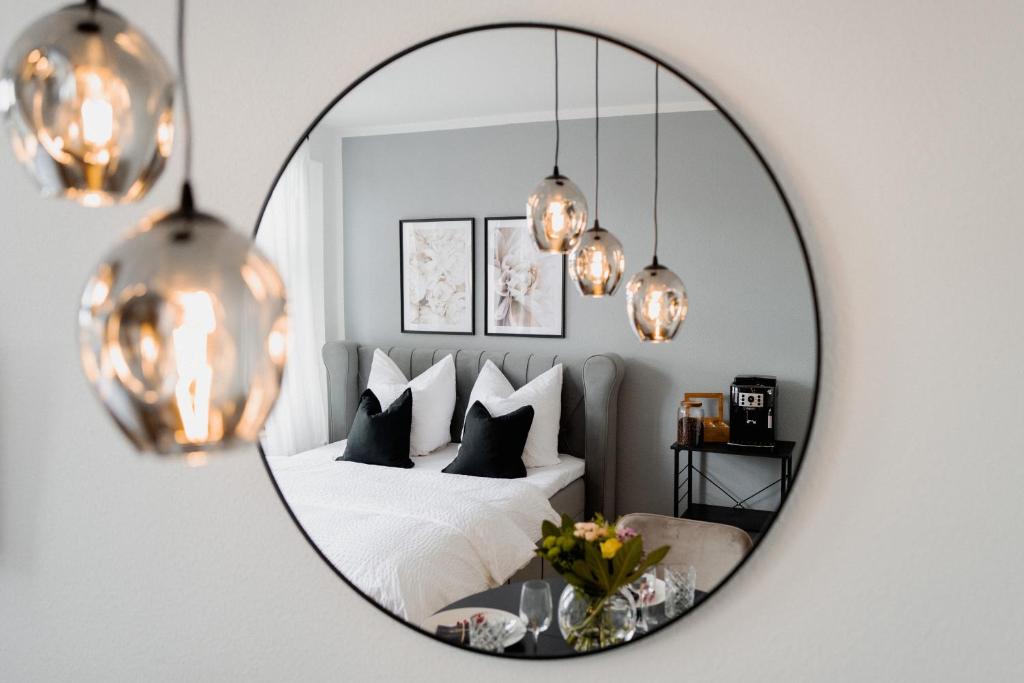 a bedroom with a bed and a mirror at Designoase für 3 mit Blick auf den Wismarer Hafen in Wismar