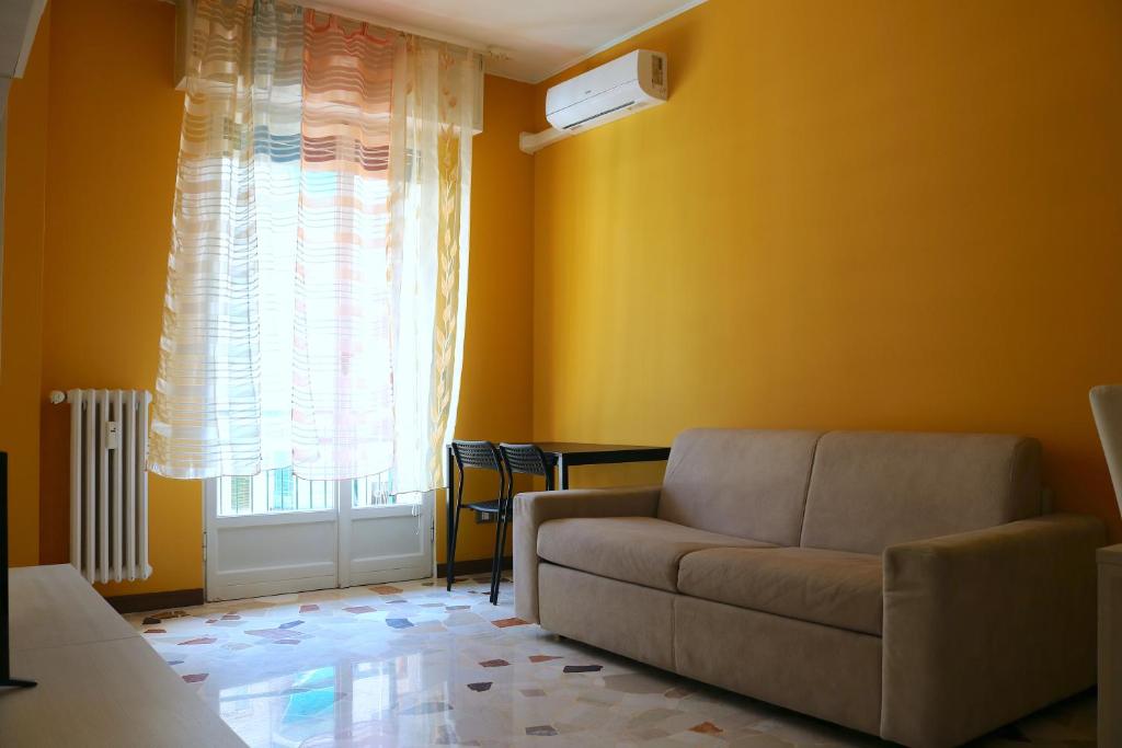 a living room with a couch and a window at Frattini Comfy family Home - 4 People in Milan