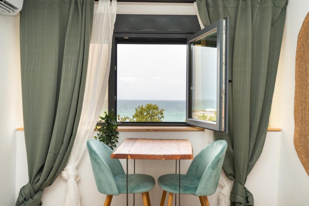 a table and two chairs in front of a window at El Mirador in Alicante