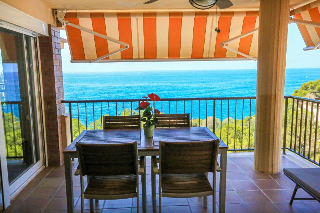 a table and chairs on a balcony with a view of the ocean at CABO Palos 4 2 2 ONLY FAMILIES in Salou