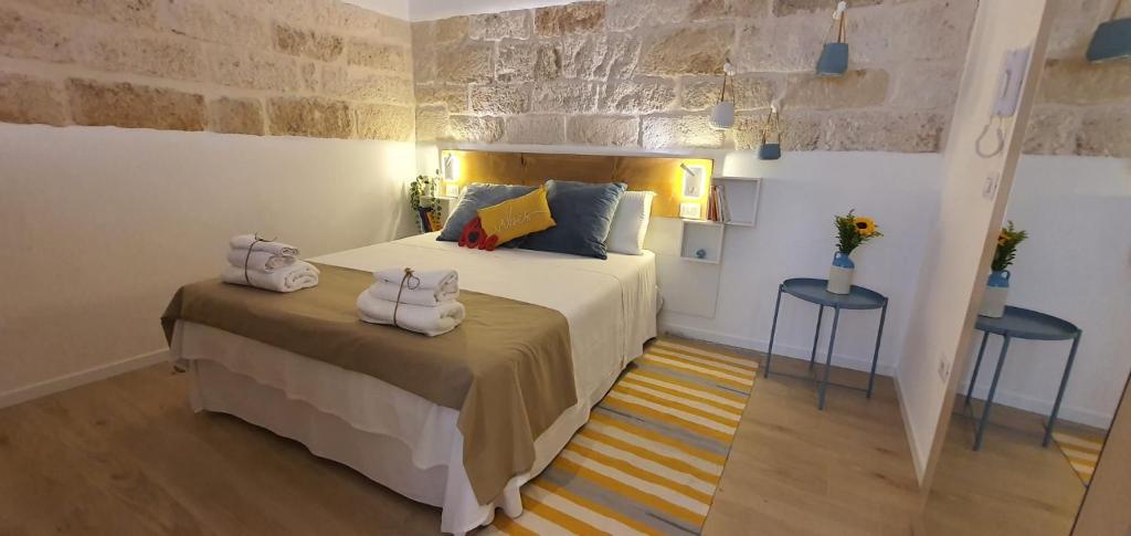 a bedroom with a bed with two towels on it at JACARANDA in Conversano
