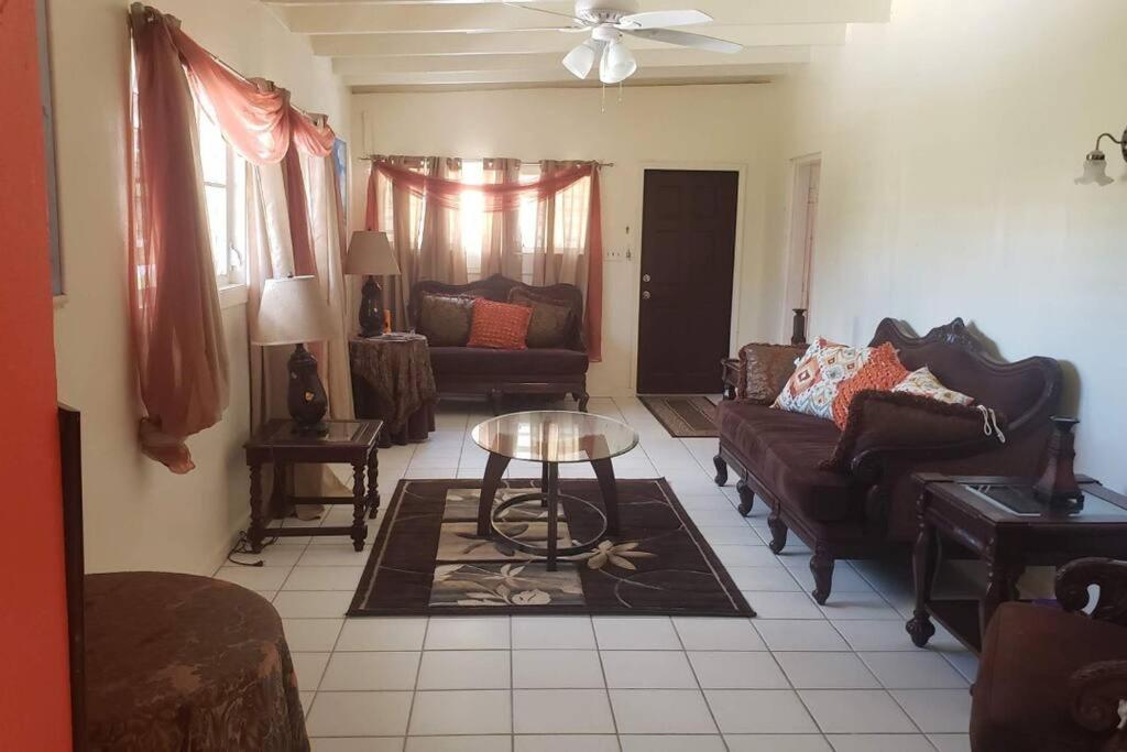 a living room with a couch and a table at 2 Bedroom 2 Bathroom House Centrally Located in Christiansted