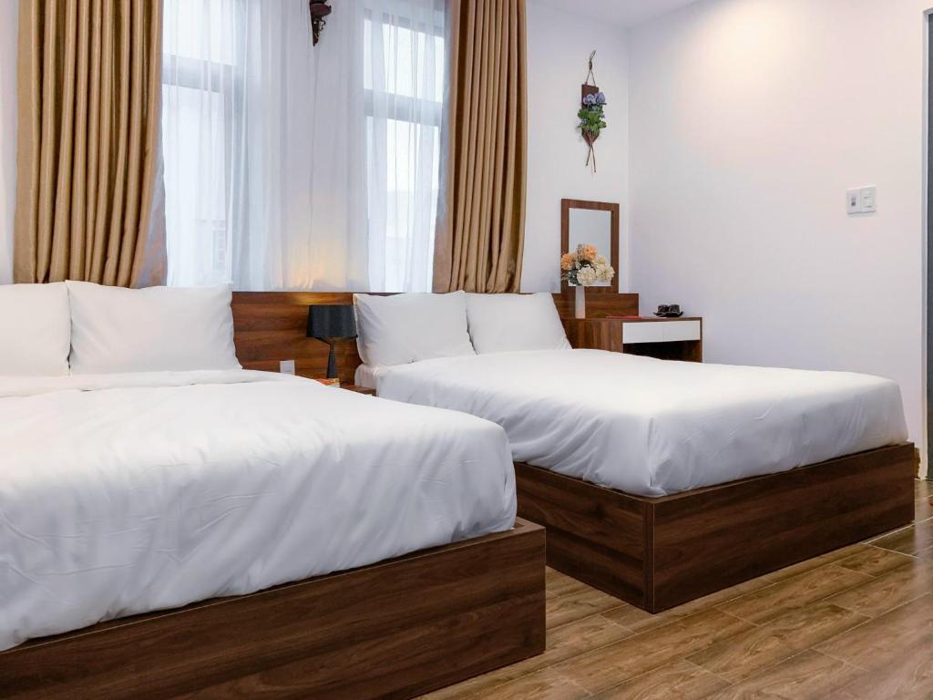 Postel nebo postele na pokoji v ubytování Nguyên Hương Hotel
